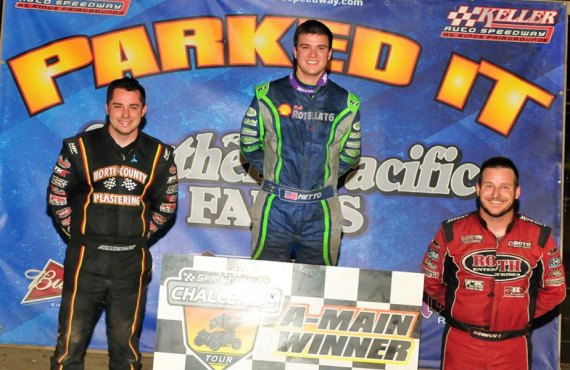 DJ Netto stands atop the winner's podium with Justin Sanders (left) and Kyle Hurst (right). 